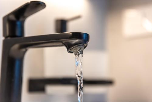 Running water from a modern bathroom sink faucet